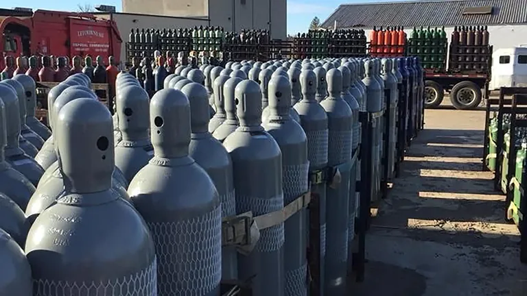 Rows of high-pressure gas cylinders staged at the Northeast Gas & Ice yard in New England